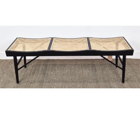 BENCH, ebonised with three caned seats, 47cm H x 140cm W x 38cm D