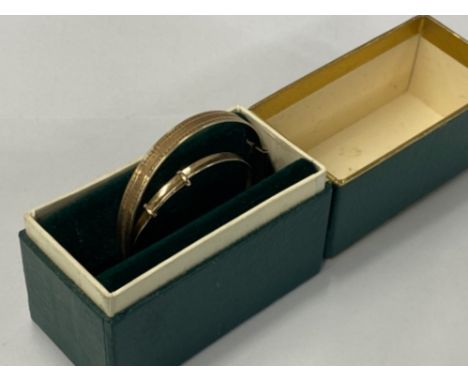 CHILDS 9CT GOLD EXPANDING BANGLE 1.4G, TOGETHER WITH A 9 CARAT GOLD 1/5TH METAL CORE GIRLS EXPANDING BRACELET 5.6G