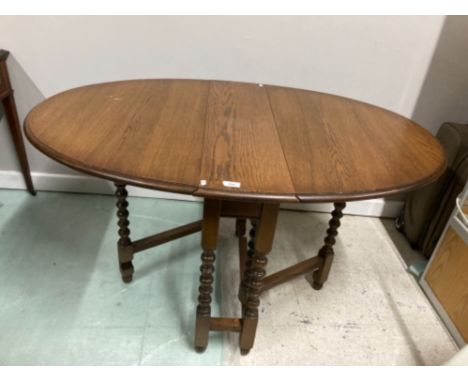 A VINTAGE OAK GATELEG DINING TABLE WITH FOUR UPHOLSTERED CHAIRS BY OLD CHARM