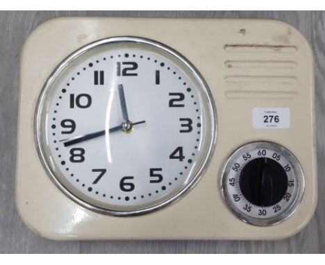 A RETRO STYLE PLASTIC WALL CLOCK WITH TIMER