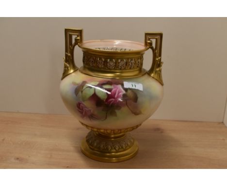A Royal Worcester two-handled vase, the everted gilt rim above a shallow neck pierced with anthemion upswept leaf and key pat