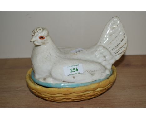 A 19th century white ceramic Staffordshire style Hen on yellow nest, W19cm x H15cm
