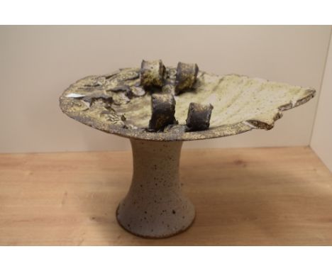 An unusual studio pottery stoneware sculpture having impressed Aztec patterns to top, supported on a cylindrical base, h23cm