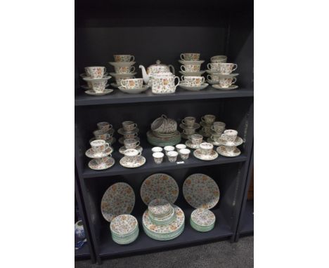 A large Minton fine bone China Haddon Hall pattern dinner service, decorated with colourful foliage motifs on a white ground,