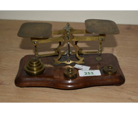 A vintage set of postal scales with metric weights, engraved POSTAL RATES FOR LETTERS NOT EXCEEDING 1oz 1d, Width18cm.