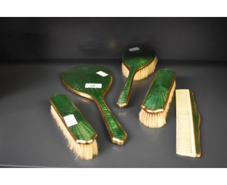 An early 20th century green enamelled dressing table set in the style of Albert Carter, comprising of hairbrush, two clothes 