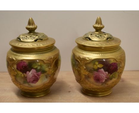 A pair of Royal Worcester porcelain pot pourri vases and covers, the bulbous bodies with gilt overall moulding cut with four 