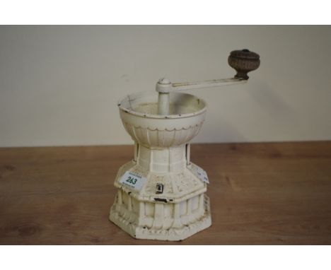 A vintage Kenrick cast iron coffee grinder in the form of a mill, having wooden handle and impressed marks to base, h20cm.