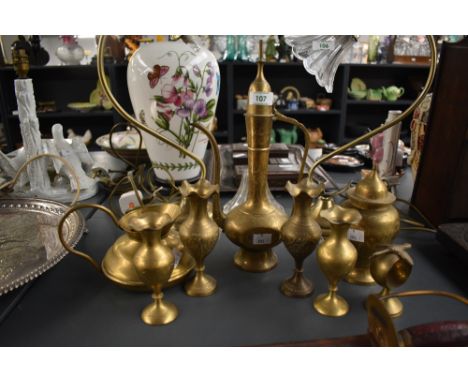 A vintage brass eastern tea pot engraved with symmetrical floral patterns, to include tea pot, water jug, sugar caddy ect, ( 