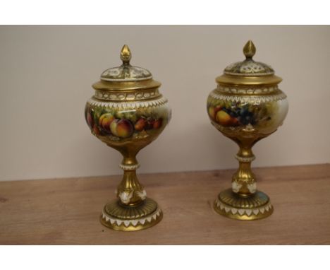A pair of Royal Worcester porcelain pot-pourri vases and covers, shape number 1813, the bulbous bodies painted with fallen fr