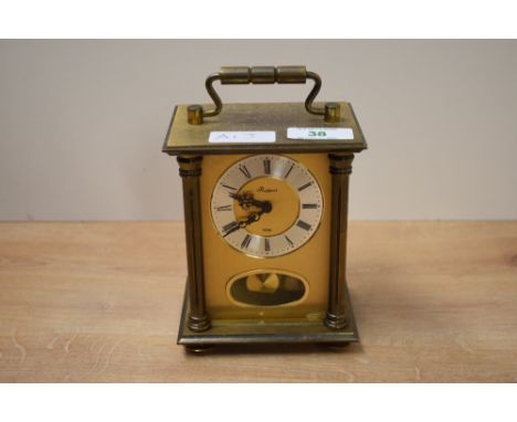 A small brass 8 day anniversary carriage clock, the face flanked by Doric columns, h14cm.