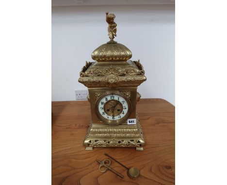 A 19th century ornate bronze mantle clock with a French movement striking on a gong with a pendulum and key - ticks but stops