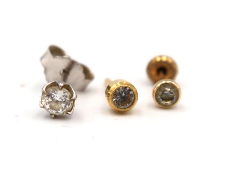 A 14ct white gold and diamond earring, the single stone of approximately 0.125ct, 0.4g,  a 14ct gold earring set with white s