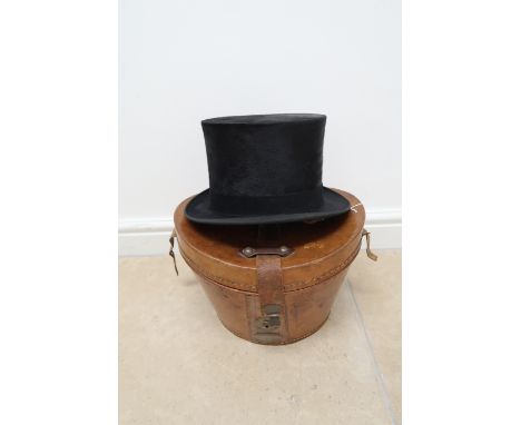 A black brushed silk top hat, the cream silk lining stamped with hatter's mark above Vienna, Paris Chicago, Antwerp below, un