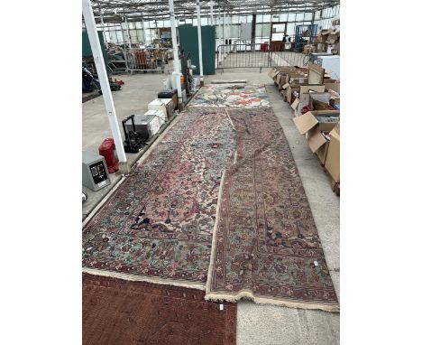 A LARGE VINTAGE PINK PATTERNED FRINGED RUG