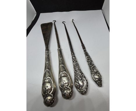 FOUR MARKED SILVER HANDLED ITEMS TO INCLUDE BUTTON HOOKS AND SHOE HORN