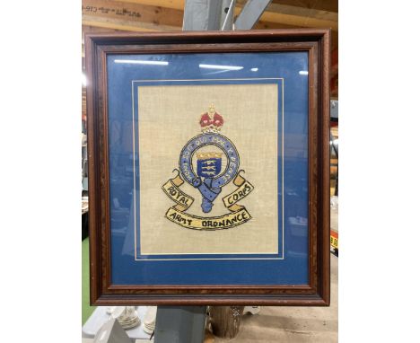 A FRAMED ROYAL ARMY ORDNANCE CORPS BADGE, STITCHED BY ANDREW LEWIS PETERS, WHILE IN HOSPITAL, 1942