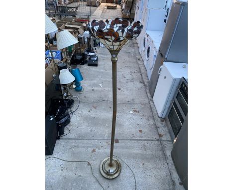 A METAL STANDARD LAMP WITH TIFFANY STYLE SHADE