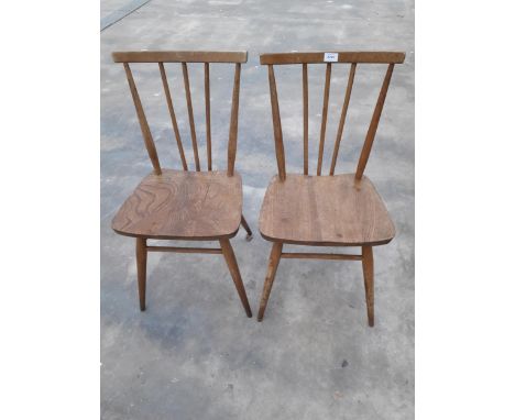 A PAIR OF ERCOL BLUE LABEL ELM AND BEECH STICK BACK DINING CHAIRS