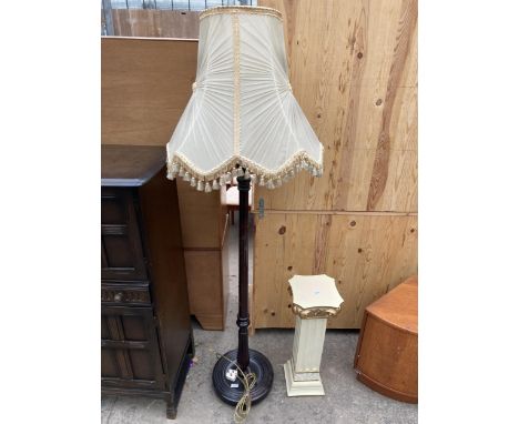 A STANDARD LAMP WITH SHADE