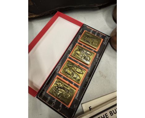 A BOX SET OF FOUR BRASS LIGHTERS WITH IMAGES OF AMERICAN VINTAGE CARS
