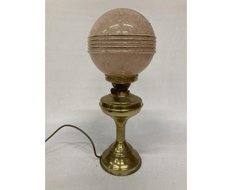 A BRASS LAMP BASE WITH PINK ART DECO GLOBE SHADE