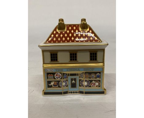 A ROYAL CROWN DERBY PAPERWEIGHT "THE CHINA SHOP" WITH CERAMIC STOPPER - 8 X 7.5 CM