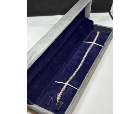 A MARKED 14 CARAT ROSE GOLD TENNIS BRACELET SET WITH FORTY ROUND BRILLIANT CUT DIAMONDS TOTAL WEIGHT 10.5 GRAMS DIAMOND WEIGH