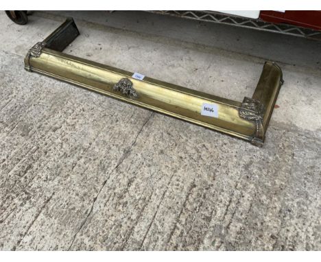 A SMALL DECORATIVE BRASS FIRE FENDER