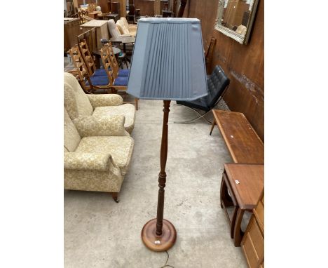 A STANDARD LAMP ON TURNED COLUMNS WITH SHADE