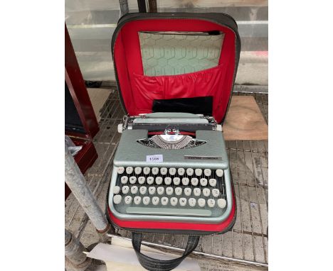 AN EMPIRE CORONA TYPEWRITER WITH CARRY CASE