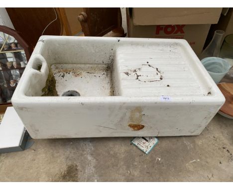 A WHITE BELFAST SINK WITH DRAINING BOARD