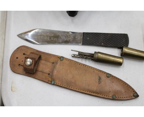 A THROWING KNIFE IN A LEATHER SHEATH, SMALL TOOLS IN A BRASS CASE