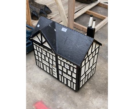 A VINTAGE BLACK AND WHITE PAINTED WOODEN DOLLS HOUSE