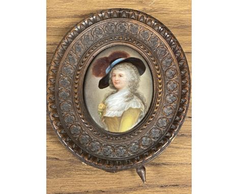A VINTAGE HAND PAINTED MINIATURE PORTRAIT IN A WOODEN FRAME