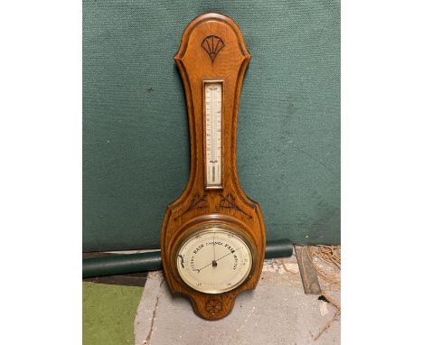 A WALL HANGING BAROMETER