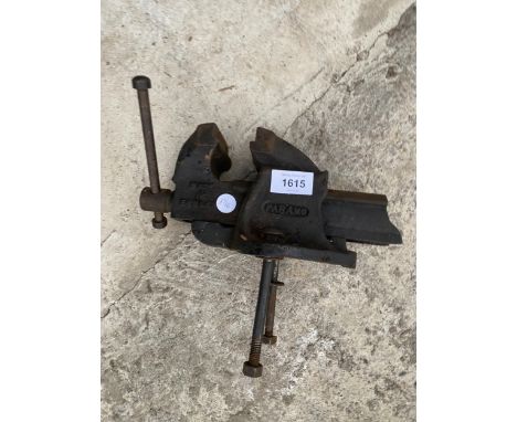A SMALL PARMO CAST IRON BENCH VICE