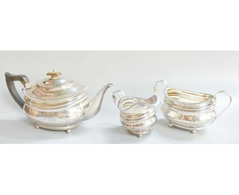 A Three-Piece Edward VII Silver Tea-Service, by Charles Stuart Harris, London, 1903, in the George III style, each piece oblo