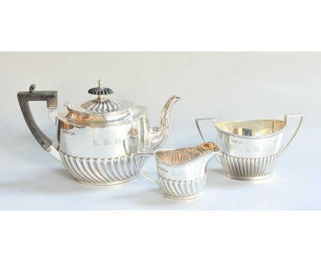 A Three-Piece Silver Tea-Service, by Walker and Hall, Sheffield, The Cream-Jug 1901, The Other Pieces 1904, each piece with s