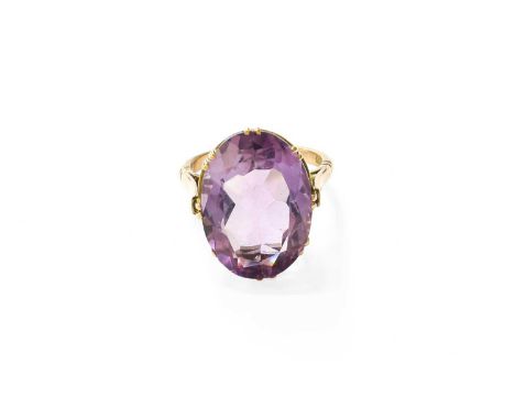 An Amethyst Ring, the oval cut amethyst in a yellow double claw setting, to a tapered shoulder plain polished shank, stamped 