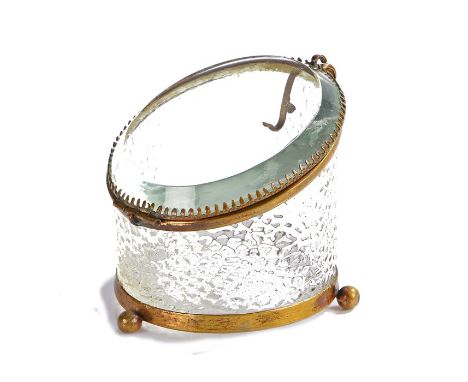 Glass and brass watch case, with bevelled sloping glass hinged lid above a scale effect glass body, raised on three orb feet,