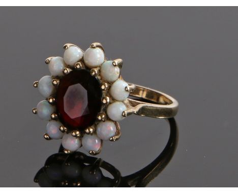 9 carat gold opal and garnet set ring, with a central garnet and opal surround, ring size P