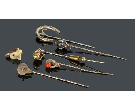 Stick pins, to include a bulls head, an eagle claw, a lantern, a horse shoe and a ball example, (5)