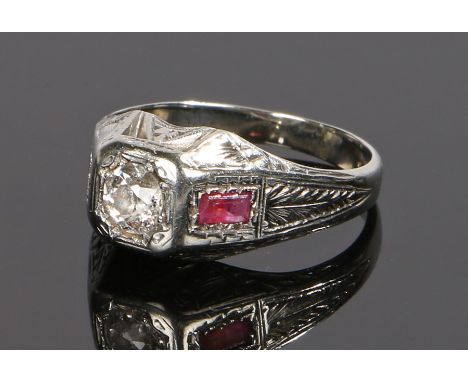 18 carat white gold diamond and ruby ring, the central diamond at approximately 0.5 carat flanked by a baguette ruby (one rub