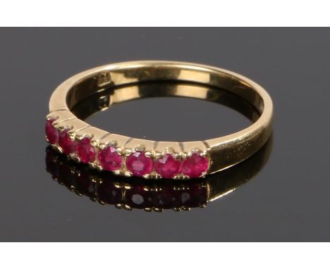 18 carat gold ruby set ring, with a row of seven rubies, ring size M 1/2