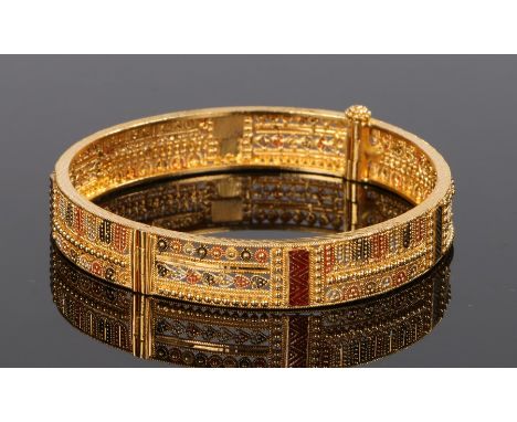 Middle Eastern 22 carat gold filigree and enamel bracelet, the bracelet decorated with red and black enamel, 70mm diameter, 2