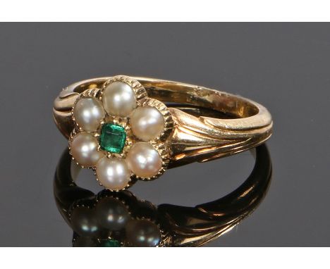 Emerald and pearl set ring, with a central emerald and pearl surround to form a flower head design, ring size I