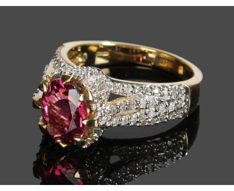 9 carat gold pink tourmaline and diamond set ring, with a central 1.71 carat oval cut tourmaline and a forty diamond surround