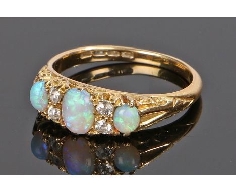 18 carat gold opal and diamond set ring, the head set with three opals and four diamonds, ring size O