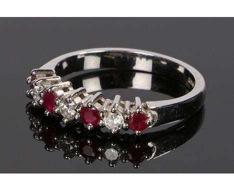 18 carat white gold ruby and diamond ring, with three diamonds and four rubies, ring size O